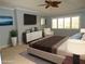 Bright primary bedroom with a ceiling fan, large windows, a TV, a dresser, and a comfortable bed with throw pillows at 903 Pinellas Bayway S # 302, Tierra Verde, FL 33715