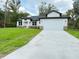 Charming single-story home featuring a manicured lawn and a spacious two-car garage at 1074 Kacerik St, North Port, FL 34288