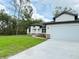 Single-story home with a well-maintained lawn and driveway leading to a spacious two-car garage at 1074 Kacerik St, North Port, FL 34288