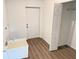 Bright mud room features a utility sink, wood-look floors, and access to a closet and the backyard at 1074 Kacerik St, North Port, FL 34288