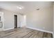 Bedroom featuring wood-look floors, closet, and hallway access at 11335 Pickford St, Spring Hill, FL 34609