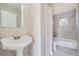 Bathroom with pedestal sink, toilet and bathtub at 11335 Pickford St, Spring Hill, FL 34609