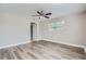 Bright bedroom with hardwood floors, ceiling fan, and access to bathroom at 11335 Pickford St, Spring Hill, FL 34609