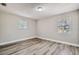Simple bedroom with wood-look floors and two windows at 11335 Pickford St, Spring Hill, FL 34609