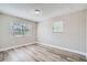 Spacious bedroom featuring two windows and wood-look floors at 11335 Pickford St, Spring Hill, FL 34609