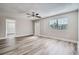 Living area with hardwood floors, ceiling fan, and access to other rooms at 11335 Pickford St, Spring Hill, FL 34609