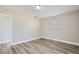 Bedroom with wood-look floors, window, and access to hallway at 11335 Pickford St, Spring Hill, FL 34609