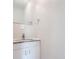 Clean bathroom with granite countertop vanity, rectangular mirror and white walls at 11335 Pickford St, Spring Hill, FL 34609