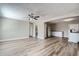 Open living room features hardwood floors, ceiling fan and kitchen views at 11335 Pickford St, Spring Hill, FL 34609