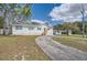 White single-story home with a gravel driveway at 11335 Pickford St, Spring Hill, FL 34609