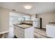Modern kitchen features granite countertops, stainless steel appliances, and white cabinets at 11335 Pickford St, Spring Hill, FL 34609