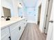 Modern bathroom showcases a double vanity, new fixtures, and a glass-enclosed shower with a niche at 4683 Boston Ter, North Port, FL 34288