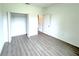 Bright bedroom with light grey wood floors, a walk-in closet, and white trim at 4683 Boston Ter, North Port, FL 34288