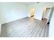 Large bedroom with a hall, bathroom, and walk-in closet, along with durable wood-look floors at 4683 Boston Ter, North Port, FL 34288