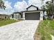 Inviting home exterior with a paved driveway, offering a glimpse of the front yard and modern design at 4683 Boston Ter, North Port, FL 34288