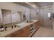 Spa-like bathroom with double vanity, large mirror, and a walk-in shower at 4683 Boston Ter, North Port, FL 34288