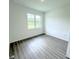 Neutral bedroom with bright window and laminate flooring at 1081 Mccrory St, North Port, FL 34286