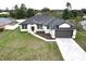 Charming new construction with paver driveway and neutral colors in a nicely landscaped neighborhood at 1081 Mccrory St, North Port, FL 34286