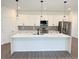 Modern kitchen featuring a center island, stainless steel appliances, and stylish pendant lighting at 1081 Mccrory St, North Port, FL 34286