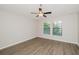 Bright bedroom with wood-look floors and ceiling fan at 12413 Streambed Dr, Riverview, FL 33579