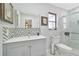 Modern bathroom with gray vanity, tile shower, and updated fixtures at 901 Don Juan Ct, Punta Gorda, FL 33950