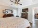 Main bedroom with king-size bed, dresser, and access to an office at 10342 Echo Dock Loop, San Antonio, FL 33576