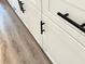 New white cabinets with dark, modern hardware at 1294 Napoleon Rd, North Port, FL 34288