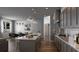 Modern kitchen with gray cabinets, marble island, and stainless steel appliances at 1294 Napoleon Rd, North Port, FL 34288