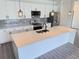 Bright kitchen with a quartz island, sleek stainless steel appliances, and stylish pendant lighting at 1294 Napoleon Rd, North Port, FL 34288
