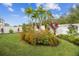Tropical garden with palm trees and colorful flowers at 307 Shore Crab Way, Apollo Beach, FL 33572
