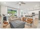 Spacious living room with grey sofas, ottoman, and view into kitchen at 307 Shore Crab Way, Apollo Beach, FL 33572