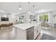 Open concept kitchen features a large island, white cabinets, and stainless steel appliances at 307 Shore Crab Way, Apollo Beach, FL 33572