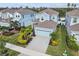 Two-story home with light blue exterior and a two-car garage at 307 Shore Crab Way, Apollo Beach, FL 33572