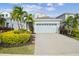 Two-story house with light blue exterior, gray roof and a paved driveway at 307 Shore Crab Way, Apollo Beach, FL 33572
