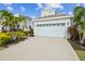 Two-story house with light blue exterior, gray roof and a paved driveway at 307 Shore Crab Way, Apollo Beach, FL 33572