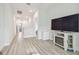 Clean and bright hallway with wood-look flooring and access to other rooms at 307 Shore Crab Way, Apollo Beach, FL 33572
