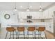 Modern kitchen with white cabinets, quartz countertops, and island with seating at 307 Shore Crab Way, Apollo Beach, FL 33572