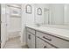 Modern bathroom with double vanity, gray cabinets, and a large mirror at 307 Shore Crab Way, Apollo Beach, FL 33572
