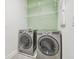 Laundry room with washer, dryer, and ample shelving at 307 Shore Crab Way, Apollo Beach, FL 33572