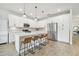 Modern kitchen with white cabinets, quartz countertops, and island with seating at 307 Shore Crab Way, Apollo Beach, FL 33572