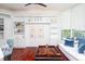 Home library with built-in shelving, hardwood floors, and a comfortable seating area at 340 S Palm Ave # 11, Sarasota, FL 34236