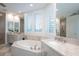 Modern bathroom with double vanity, soaking tub and large shower at 340 S Palm Ave # 11, Sarasota, FL 34236