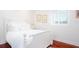 Charming bedroom with a white poster bed and hardwood floors at 340 S Palm Ave # 11, Sarasota, FL 34236