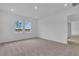 Bright bedroom featuring neutral carpet, recessed lighting, and a picturesque lake view from the double windows at 2626 Wise River Lane, Zephyrhills, FL 33539