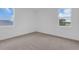 Bedroom featuring carpeted floors, windows offering great views, and neutral walls at 2626 Wise River Lane, Zephyrhills, FL 33539