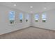 Bright bedroom with large windows offering expansive views of the green landscape at 2626 Wise River Lane, Zephyrhills, FL 33539