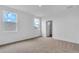 Bedroom with neutral carpet, bright windows, and a convenient closet entryway at 2626 Wise River Lane, Zephyrhills, FL 33539