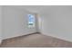 Bedroom featuring a window, carpet floors, and neutral walls at 2626 Wise River Lane, Zephyrhills, FL 33539