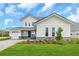 Charming two-story home featuring a two-car garage, stone accents, and well-manicured landscaping at 2626 Wise River Lane, Zephyrhills, FL 33539