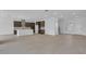 Bright, open-concept living area featuring tile floors and a gourmet kitchen with an island at 2626 Wise River Lane, Zephyrhills, FL 33539